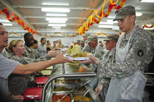 On Thanksgiving Day 2011, leaders of the 2nd Battalion, 135th Infantry (2-135 Inf.) serve the troops of 1st Brigade Combat Team, 34th Infantry Division "Red Bulls" on Camp Buehring, Kuwait. 