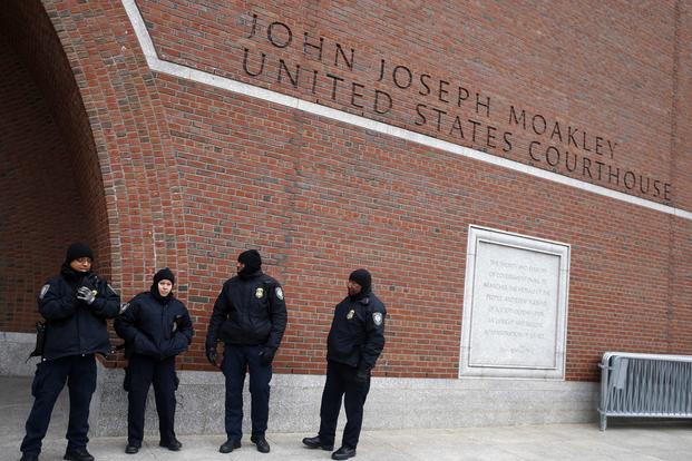 Police stand guard outside the federal courthouse in Boston
