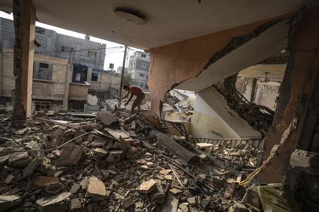 A Palestinian checks the destruction after Israeli strikes on the Gaza Strip.