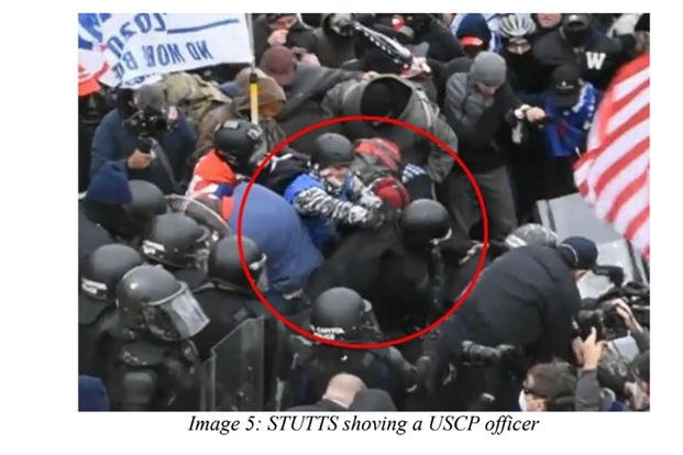 Lee Stutts shoves a U.S. Capitol Police officer in this image from closed-circuit police video included in a criminal indictment against Stutts. 