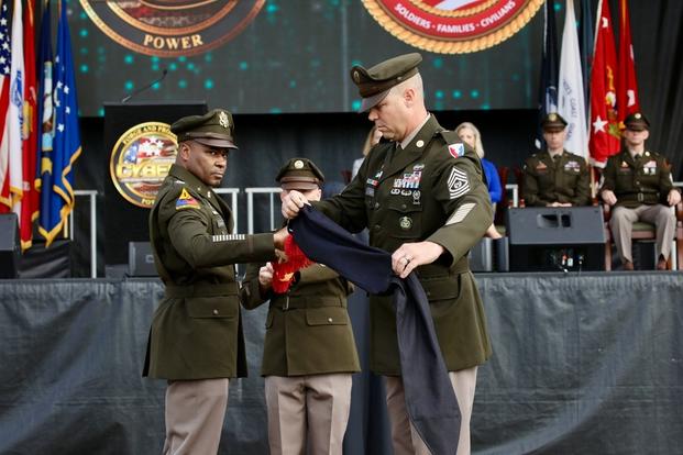 Garrison Commander, Col. Reginald Evans and Garrison Command Sgt Maj. Aaron Rose, unveil the colors at the redesignation on Fort Eisenhower, Ga on October 27th, 2023.