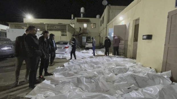 People look over some of the bodies at Al Aqsa hospital in Deir El Balah, Gaza on Dec. 24, 2023.