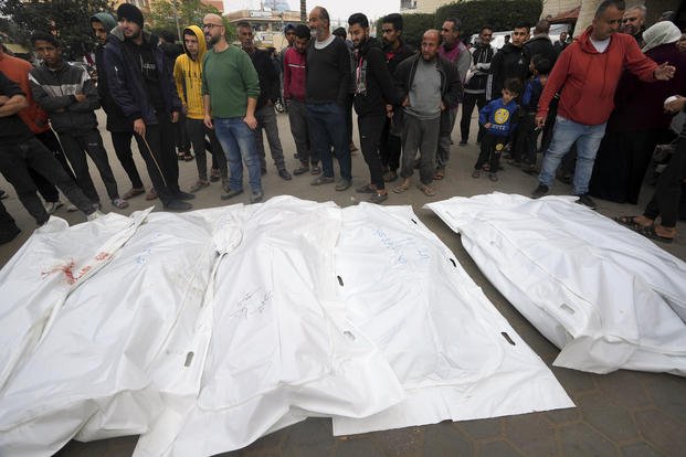 Palestinians mourn their relatives killed in the Israeli bombing of the Gaza Strip in Deir al Bala