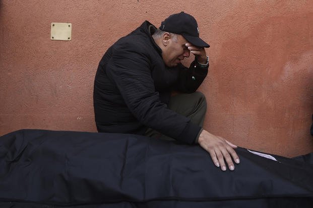 A Palestinian man mourns a relative killed in the Israeli bombardment.