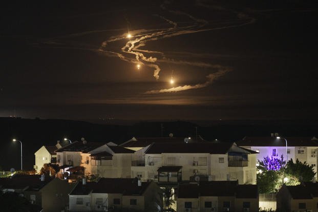 Flares rise over the Gaza Strip as seen from southern Israel