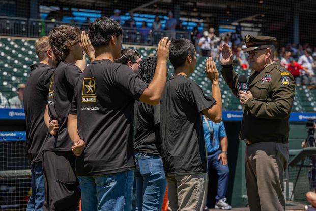 Six new recruits sworn in at a baseball game