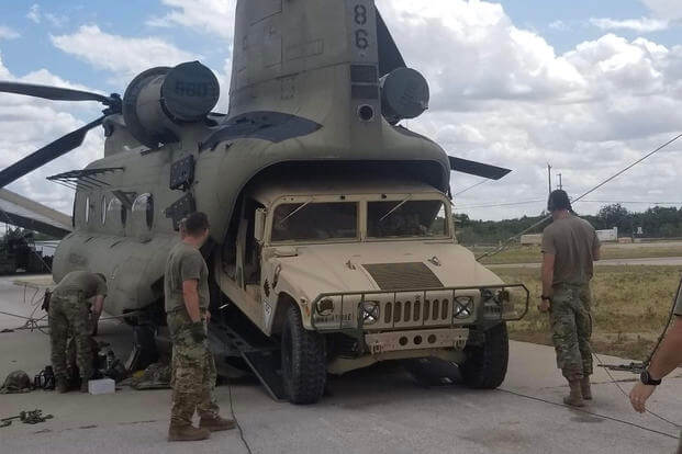 A Humvee is loaded onto a CH-47 Chinook helicopter during an air assault training mission at Fort Hood, Texas.