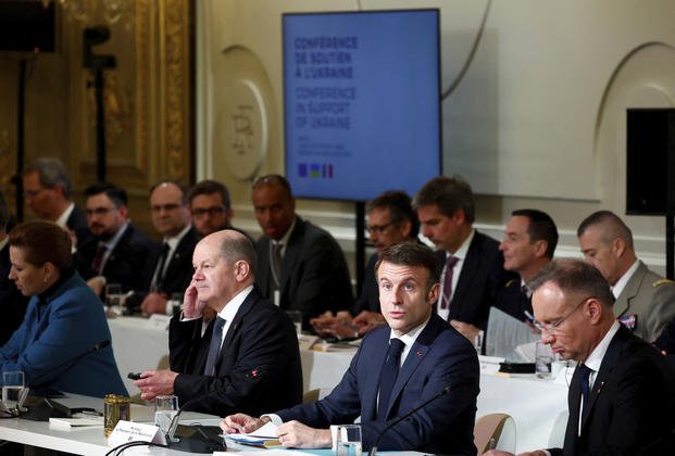 French President Emmanuel Macron, center right, delivers a speech at the Elysee Palace in Paris