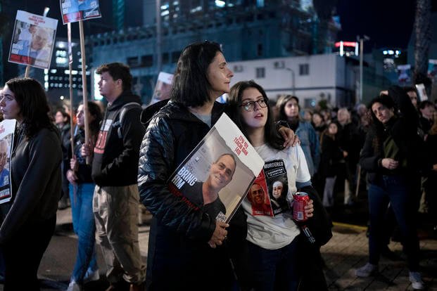 Women listen to a speaker during a weekly rally calling for the release of hostages.