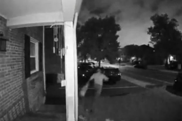 This image from a Ring home-security system shows a suspect taking a Pride flag from a homeowner's porch.