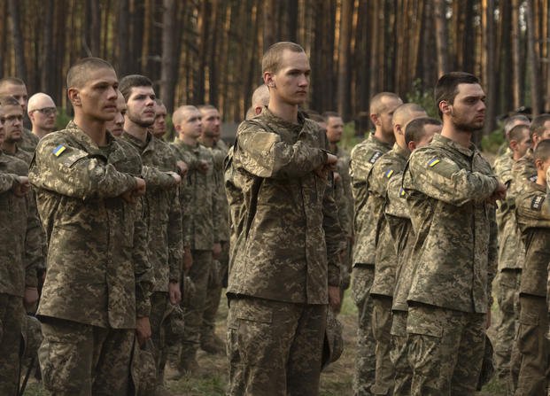Newly recruited soldiers of Ukraine's 3rd Assault Brigade line up at a military base close to Kyiv