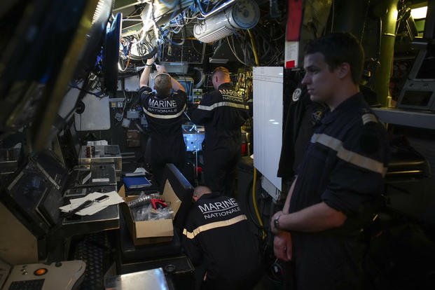 Sailors prepare a French Rubis-class submarine at the Toulon naval base