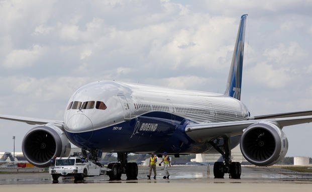 Boeing employees walk the new Boeing 787-10 Dreamliner down towards the delivery ramp