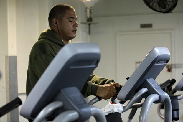 Sgt. Christopher Martinez, motor transport operator, Transportation Support Detachment, Combat Logistics Battalion 15, 15th Marine Expeditionary Unit, exercises on an elliptical machine aboard the USS Rushmore.
