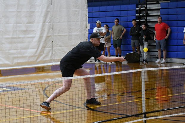 Community members at Fort Drum, New York, compete in a pickleball tournament inside the Magrath Sports Complex gymnasium.