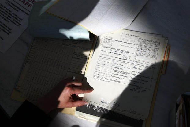 A journalist reads the recently declassified personnel file of Office of Strategic Services (OSS) member and famed chef Julia Child, Thursday, Aug. 14, 2008, in the textual research room of the National Archives in College Park, Md. 