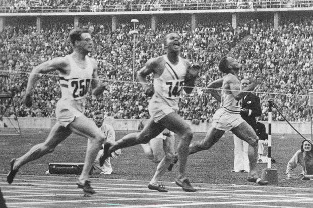 Archie Williams (center) edges Godfrey Brown (left) of Great Britain and James Lu Valle of the United States to win the gold medal in the 400 meters at the 1936 Olympics in Berlin. Brown earned the silver. (Wikimedia Commons)