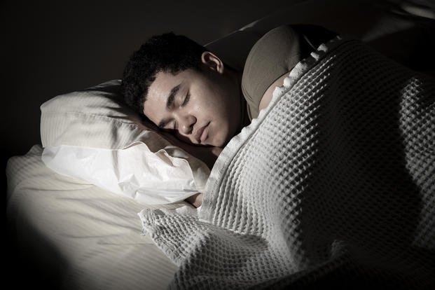 A service member sleeps after his duty day at Joint Base San Antonio–Lackland, Texas.