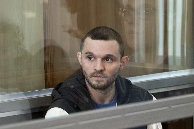 U.S. Army Staff Sgt. Gordon Black sits in a glass cage in a courtroom in Vladivostok, Russia.