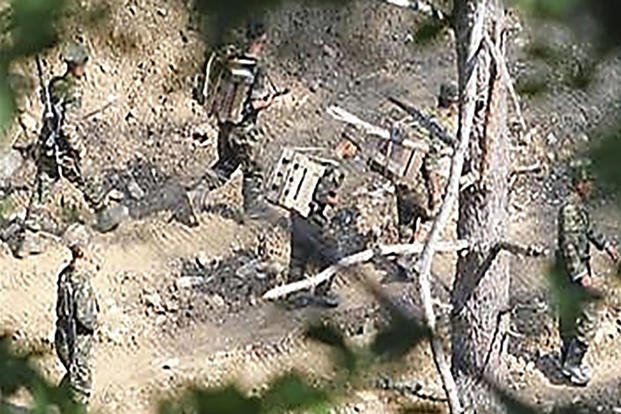 North Korean soldiers work at an undisclosed location near the border area