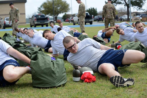 Tactical air control party candidates stretch before performing a 1.5-mile run for the physical ability and stamina test on March 20, 2015, at Moody Air Force Base, Ga. 