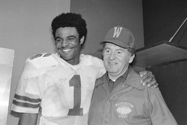 In this Jan. 2, 1978, file photo, University of Washington quarterback Warren Moon poses with coach Don James after the Rose Bowl in Pasadena, Calif. 