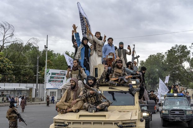 Taliban fighters celebrate one year since they seized the Afghan capital