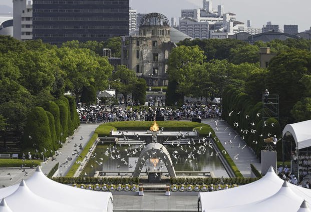 Doves fly over the cenotaph dedicated to the victims of the atomic bombing