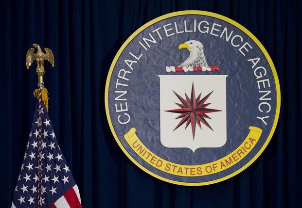The seal of the Central Intelligence Agency stands next to a U.S. flag at CIA headquarters in Langley, Va.