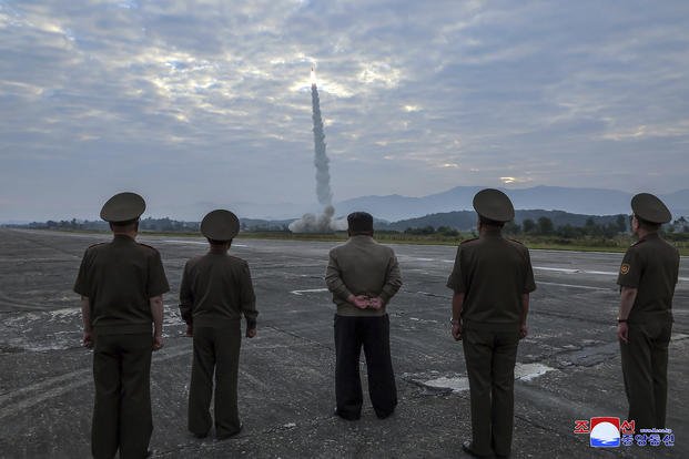  North Korean leader Kim Jong Un, center, oversees a launch