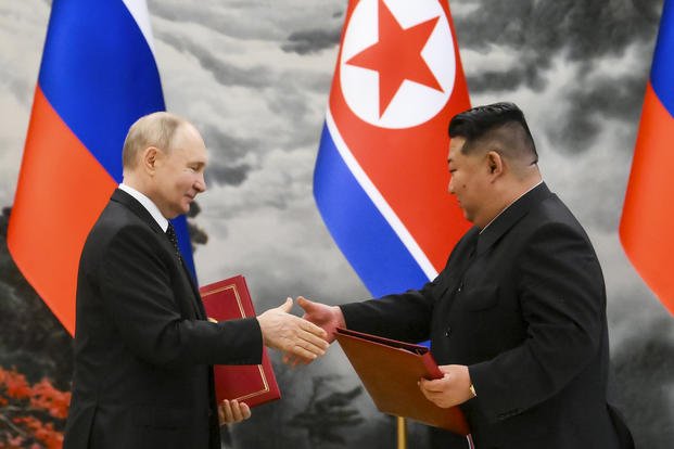  Russian President Vladimir Putin, left, and North Korea's leader Kim Jong Un