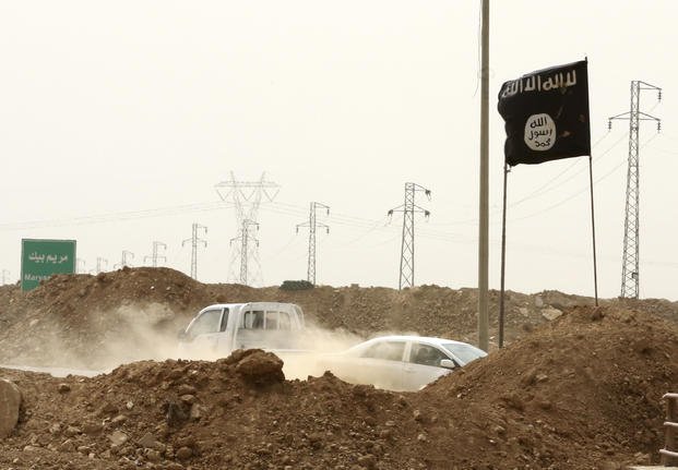Islamic State militants pass a checkpoint in the village of Maryam Begg in Kirkuk
