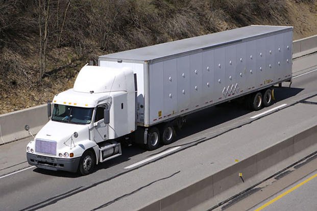 White long-haul truck on the highway.