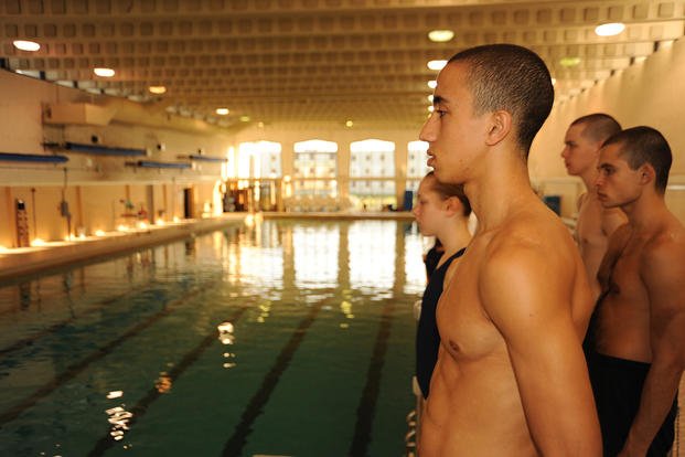 Coast Guard recruits prepare to jump from a platform into the pool below and begin their swim assessment aboard Training Center Cape May, N.J. 