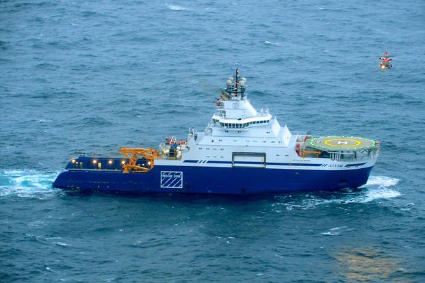 A U.S. Coast Guard MH-60 Jayhawk helicopter assigned to Coast Guard Air Station Kodiak delivers parts to the oil exploration support vessel Aiviq