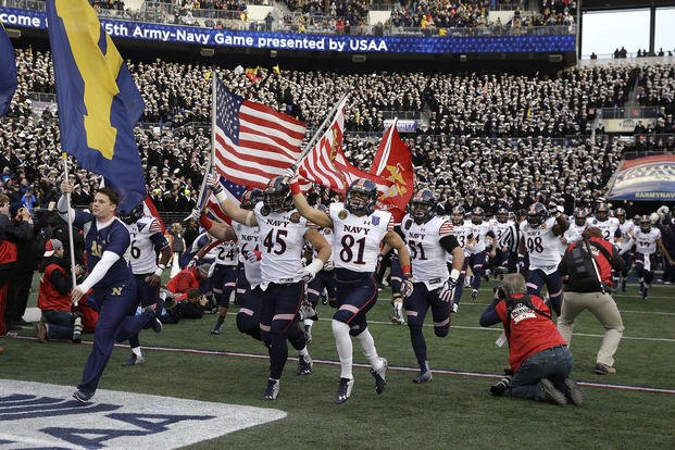 Navy’s players run onto the field before the 2014 Army-Navy NCAA college football game in Baltimore.