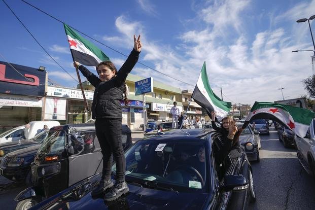 Syrians celebrate the fall of Bashar Assad's government.