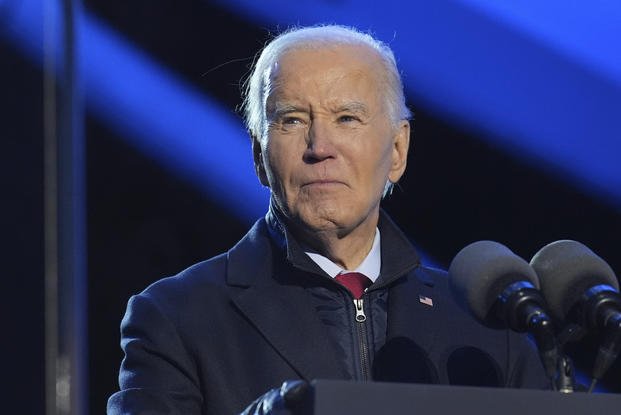 President Joe Biden speaks during a ceremony lighting the National Christmas Tree on the Ellipse