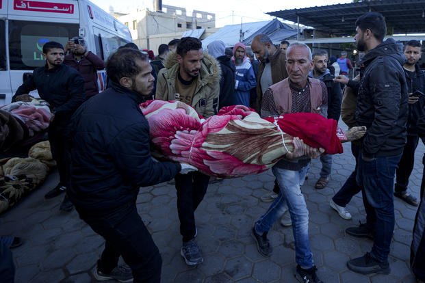 Palestinians carry the body of a relative killed in the Israeli bombardment of the Gaza Strip. 