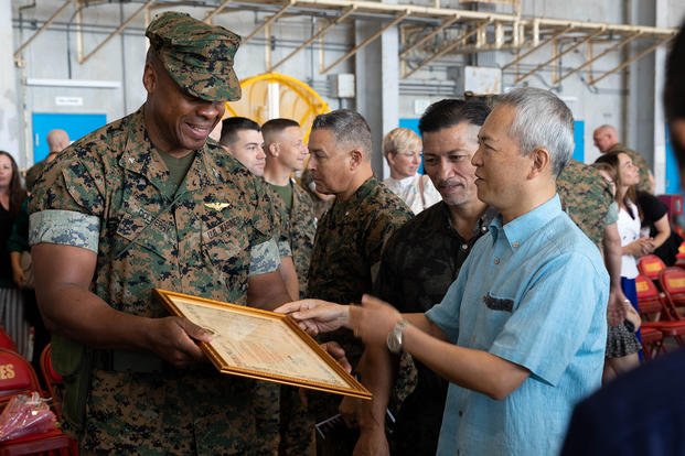 U.S. Marine Corps Col. Henry Dolberry Jr. receives a gift after a change of command ceremony on Marine Corps Air Station Futenma, Okinawa, Japan.