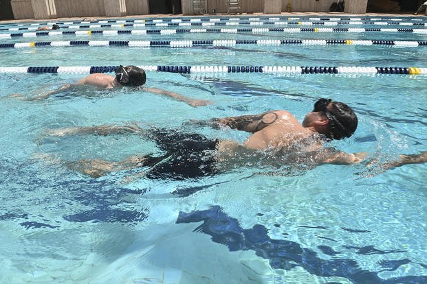 Sailors swim for the Navy Physical Screening Test held by Naval Special Warfare Assessment Command at Naval Air Station Sigonella.