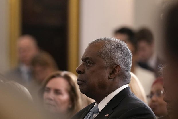 Defense Secretary Lloyd Austin listens as President Joe Biden speaks