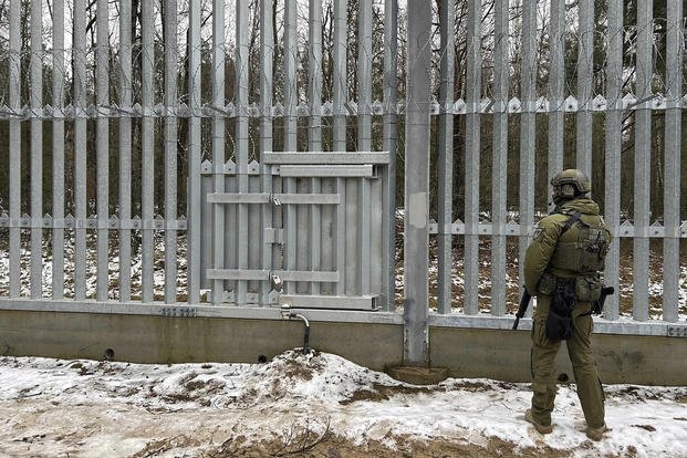 A Polish border guard looks east into Belarus at the crossing point Połowce-Pieszczatka in Poland.