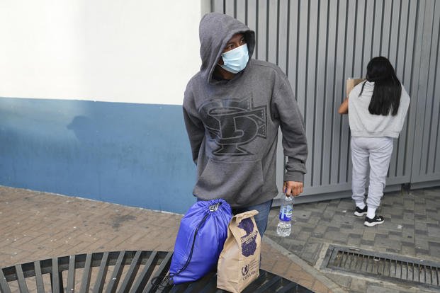 Guatemalan migrants wait to be picked up by relatives after being deported from the United States