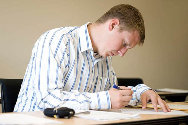 Man writing a paper.