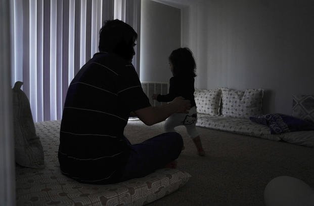 Rahmani, an Afghan refugee and father of two, plays with his daughter