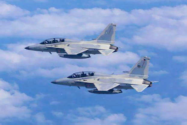 Two Philippine Air Force FA-50 fighter jets fly during a joint patrol and training session with the U.S. over the South China Sea.