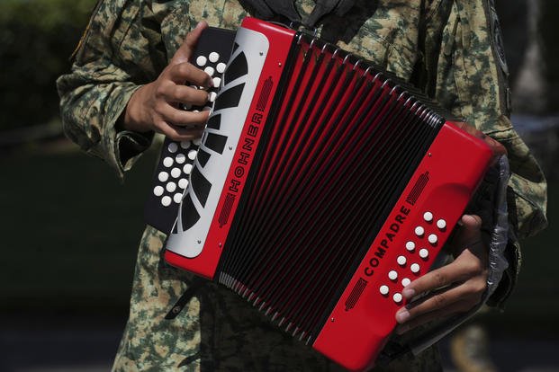 A soldier plays an accordion at a military base in Mexico City