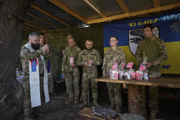 Ukrainian servicemen attend an Easter service