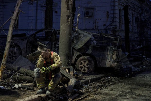 A rescue worker rests near university building destroyed by a Russian missile strike on Sumy, Ukraine.